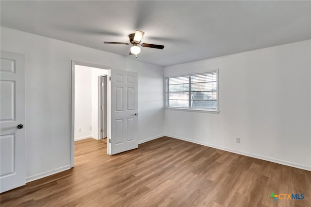 unfurnished bedroom with hardwood / wood-style floors and ceiling fan