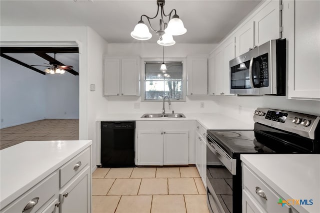 kitchen featuring stainless steel appliances, light tile patterned flooring, sink, hanging light fixtures, and white cabinets