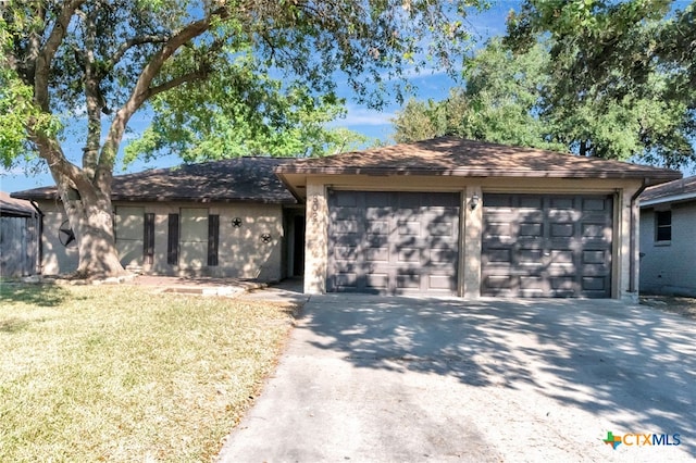 ranch-style home with a garage and a front yard