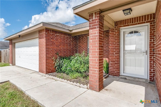 628 Cordova Loop, Seguin, TX 78155 - view of exterior entry featuring brick siding, concrete driveway, and an attached garage