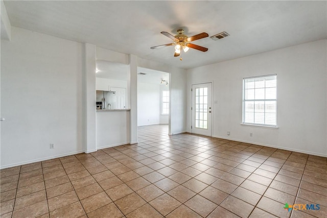 628 Cordova Loop, Seguin, TX 78155 - unfurnished living room featuring light tile patterned floors, a ceiling fan, and baseboards