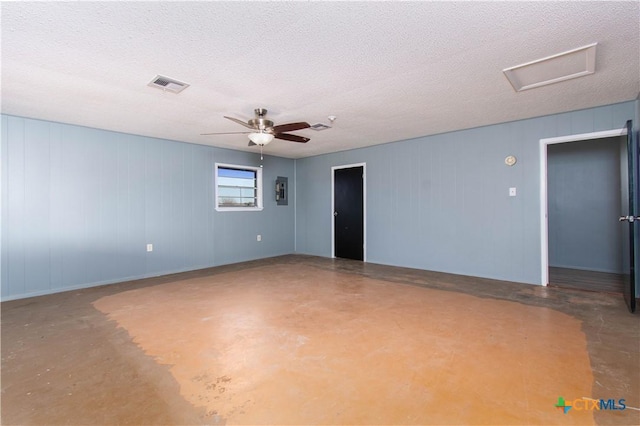 spare room with visible vents, attic access, ceiling fan, finished concrete floors, and a textured ceiling