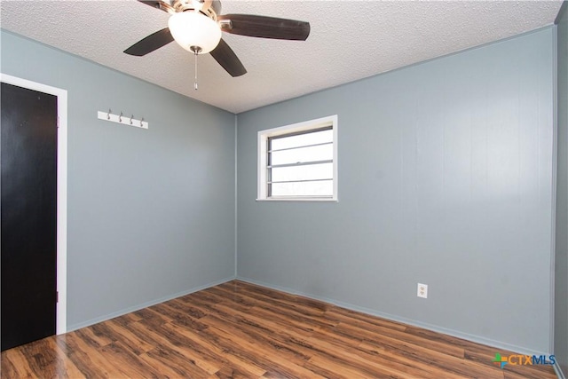 unfurnished room with ceiling fan, wood finished floors, and a textured ceiling