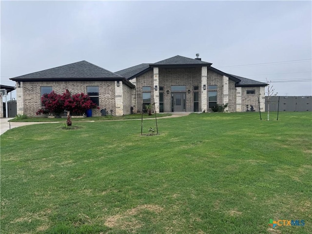 3220 Wild Seed Dr, Salado, TX 76571 - view of front of home featuring brick siding, a shingled roof, and a front yard