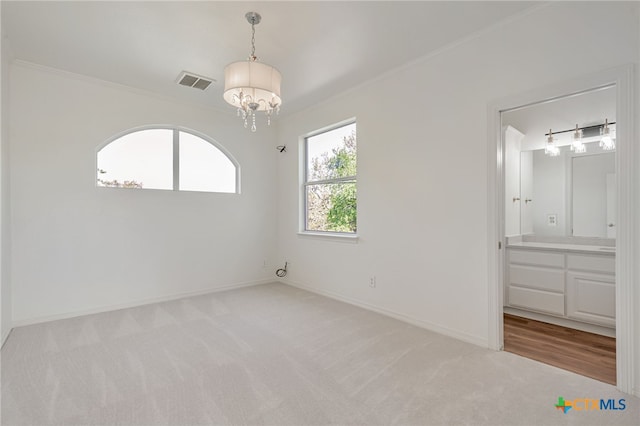 200 Tovas Secret Cv, Georgetown, TX 78628 - empty room with a chandelier, light carpet, crown molding, and baseboards