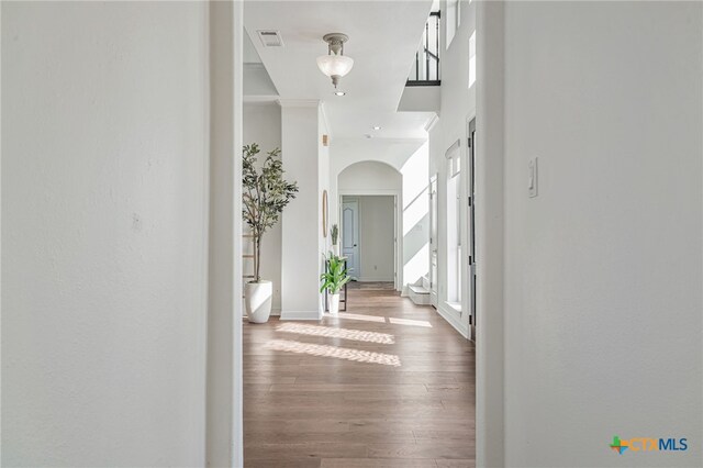200 Tovas Secret Cv, Georgetown, TX 78628 - hallway featuring arched walkways, wood finished floors, baseboards, and crown molding