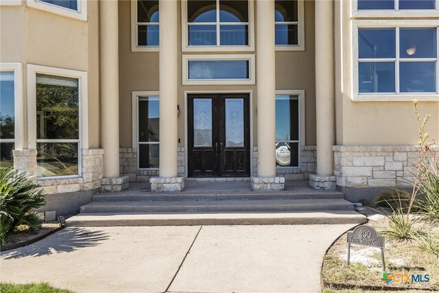 200 Tovas Secret Cv, Georgetown, TX 78628 - entrance to property with stone siding, stucco siding, and french doors