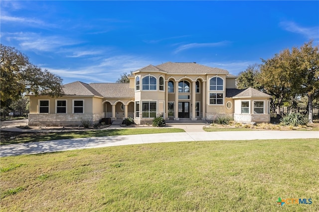 200 Tovas Secret Cv, Georgetown, TX 78628 - mediterranean / spanish-style home with a front yard, stucco siding, and curved driveway