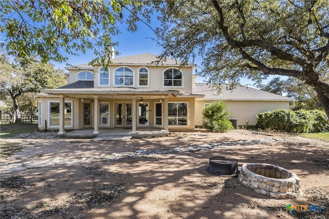 200 Tovas Secret Cv, Georgetown, TX 78628 - rear view of property featuring a fire pit, stucco siding, french doors, and roof with shingles