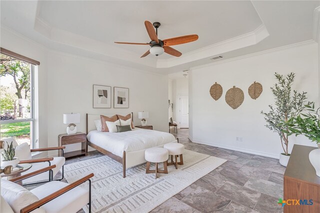 200 Tovas Secret Cv, Georgetown, TX 78628 - bedroom with a tray ceiling, stone finish floors, ornamental molding, baseboards, and ceiling fan