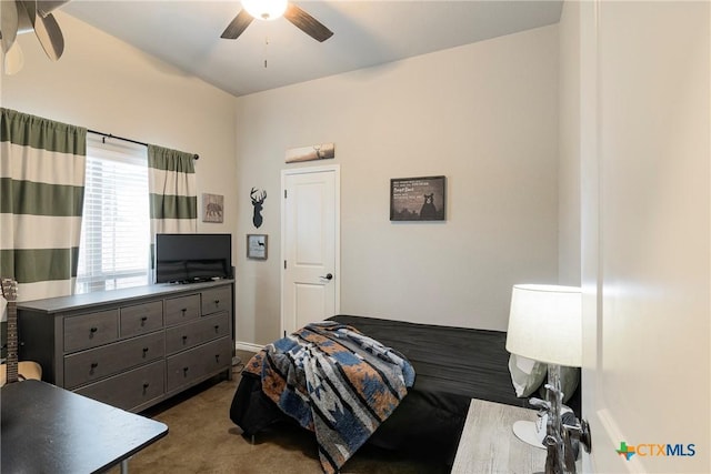 bedroom featuring ceiling fan and dark colored carpet