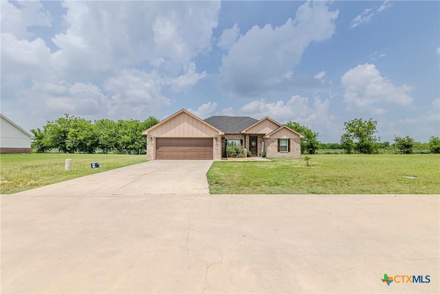 7112 Kc Ranch Ct, Temple, TX 76501 - ranch-style home featuring a garage, concrete driveway, brick siding, and a front yard