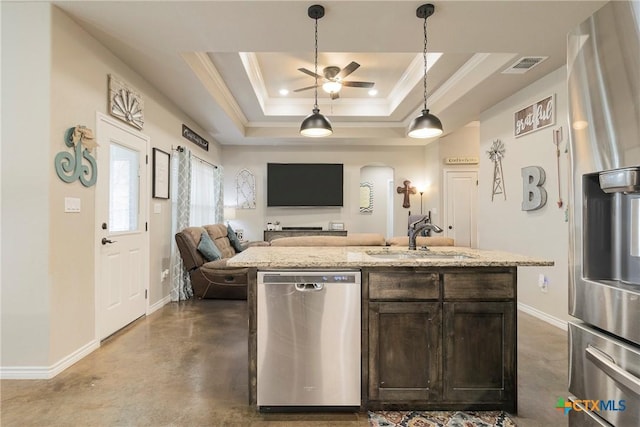 kitchen with dark brown cabinetry, a sink, visible vents, appliances with stainless steel finishes, and a tray ceiling