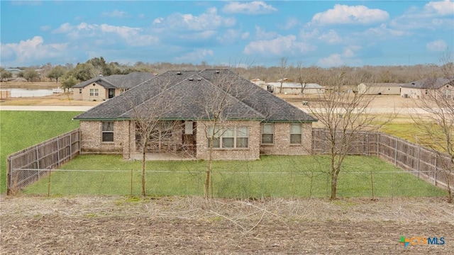 7112 Kc Ranch Ct, Temple, TX 76501 - exterior space with a lawn, brick siding, a fenced backyard, and roof with shingles