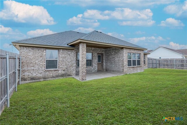 7112 Kc Ranch Ct, Temple, TX 76501 - back of property with brick siding, a patio, a fenced backyard, and roof with shingles