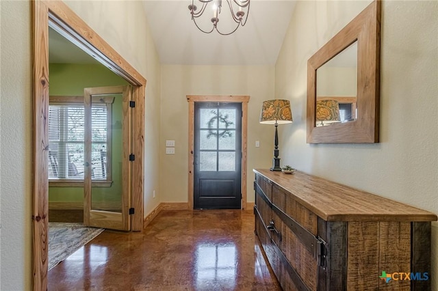 entrance foyer with concrete floors, baseboards, a chandelier, lofted ceiling, and a textured wall