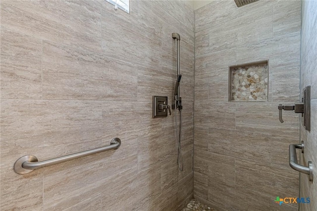 bathroom with tiled shower