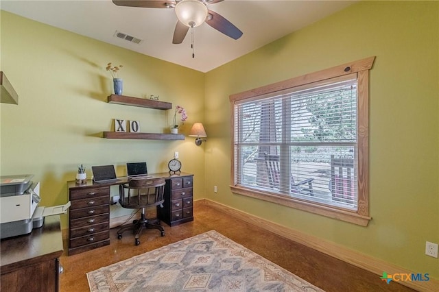 office space featuring visible vents, ceiling fan, baseboards, and carpet