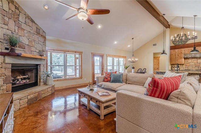 living room featuring finished concrete flooring, visible vents, baseboards, high vaulted ceiling, and a fireplace