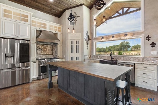343 Riverside Dr, Killeen, TX 76542 - kitchen with stainless steel appliances, wood counters, wooden ceiling, exhaust hood, and finished concrete floors
