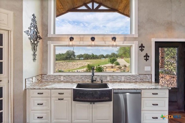 343 Riverside Dr, Killeen, TX 76542 - kitchen featuring dishwasher, a sink, light stone counters, white cabinetry, and vaulted ceiling