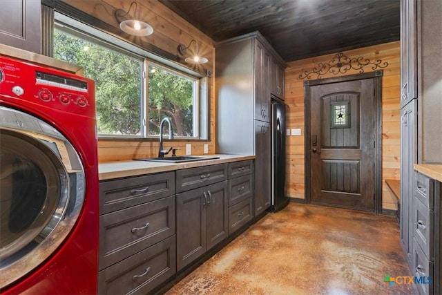 343 Riverside Dr, Killeen, TX 76542 - laundry room featuring washer / clothes dryer, cabinet space, wooden walls, and wooden ceiling