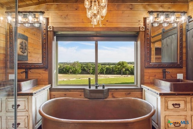 343 Riverside Dr, Killeen, TX 76542 - bathroom with wood walls, a freestanding bath, vanity, and a chandelier
