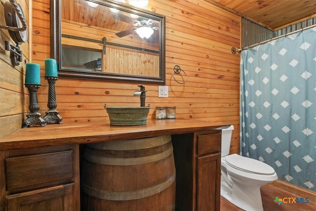 343 Riverside Dr, Killeen, TX 76542 - full bath featuring vanity, toilet, wood walls, wood ceiling, and a shower with curtain