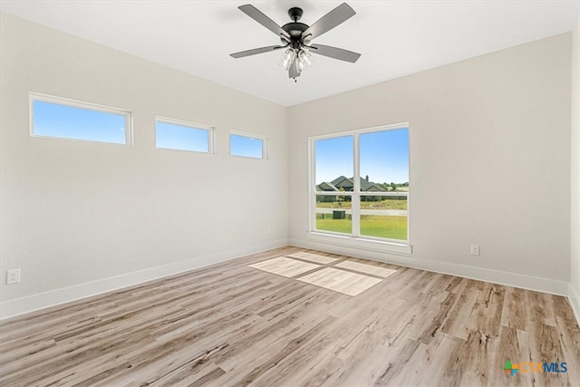 unfurnished room with light wood-type flooring and ceiling fan