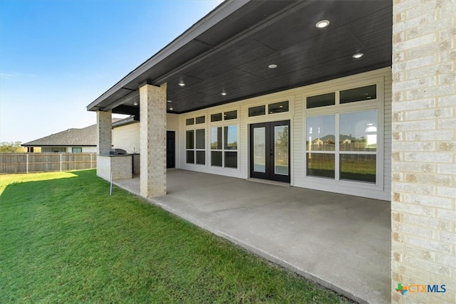 back of house featuring a lawn and a patio