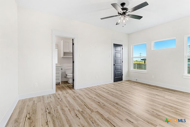 unfurnished bedroom with ceiling fan, light hardwood / wood-style floors, and ensuite bathroom