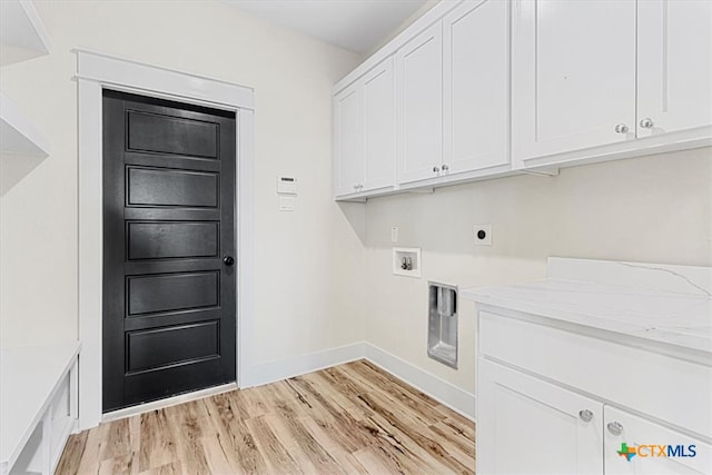 laundry room with hookup for an electric dryer, light hardwood / wood-style flooring, hookup for a washing machine, and cabinets