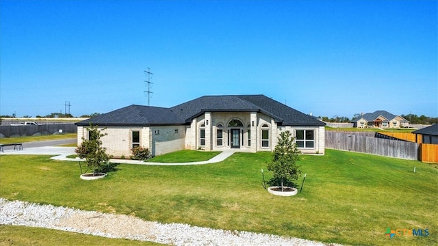 rear view of house with a yard