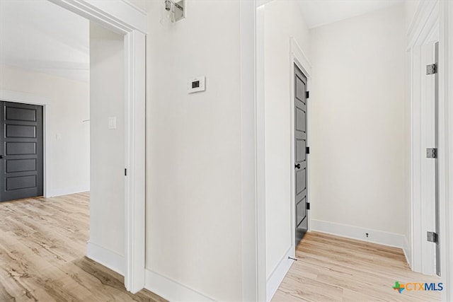 corridor with light hardwood / wood-style flooring