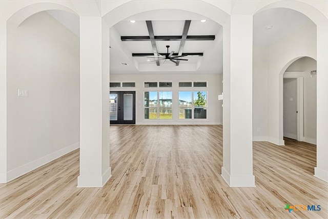 unfurnished living room featuring light hardwood / wood-style flooring, a notable chandelier, beamed ceiling, and coffered ceiling