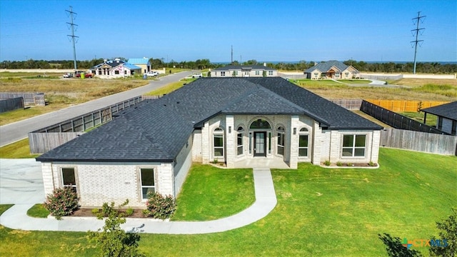 rear view of property with a yard