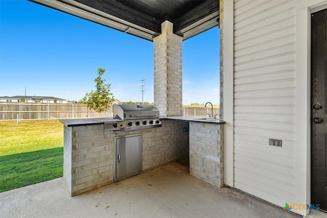 view of patio / terrace featuring grilling area, area for grilling, and sink