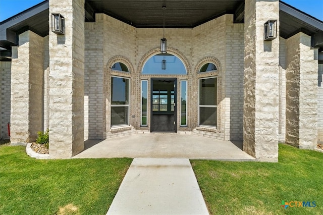 doorway to property with a lawn