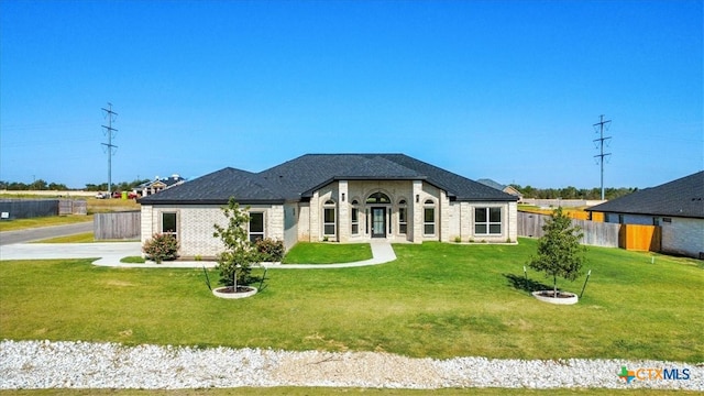 french country inspired facade featuring a front lawn