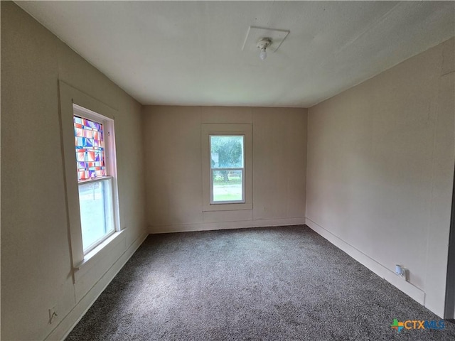 unfurnished room with baseboards and carpet