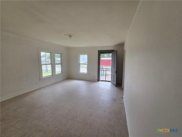unfurnished room featuring baseboards