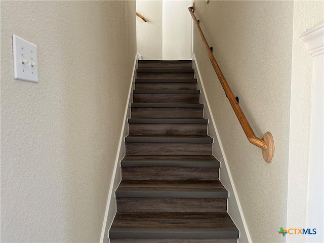 stairway with hardwood / wood-style flooring