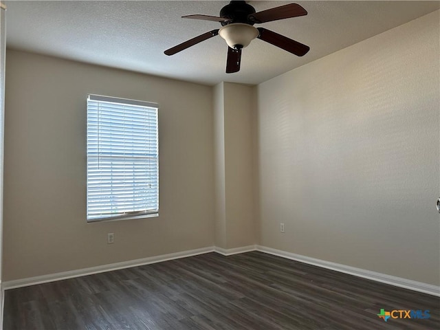 spare room featuring ceiling fan, dark hardwood / wood-style flooring, and a textured ceiling