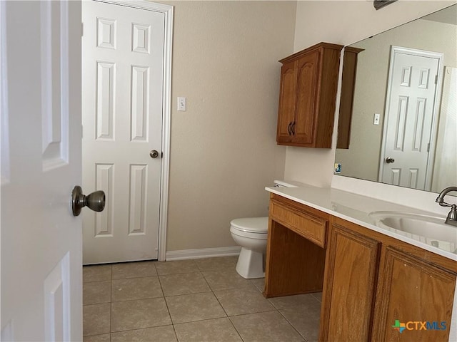 bathroom with tile patterned flooring, vanity, and toilet