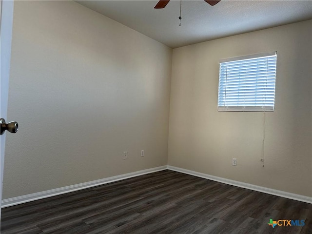 empty room with ceiling fan and dark wood-type flooring