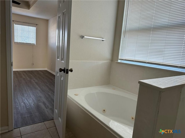 bathroom featuring a washtub and hardwood / wood-style flooring