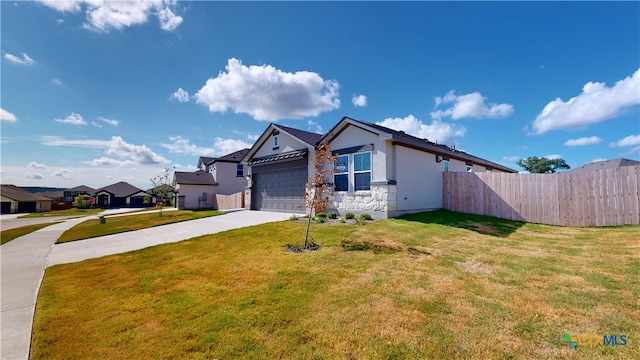 609 Waylon Cir, Killeen, TX 76542 - single story home featuring driveway, a garage, stucco siding, a residential view, and stone siding