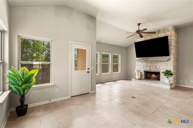 668 Peacock Ln, New Braunfels, TX 78310 - unfurnished living room featuring light tile patterned floors, plenty of natural light, and vaulted ceiling