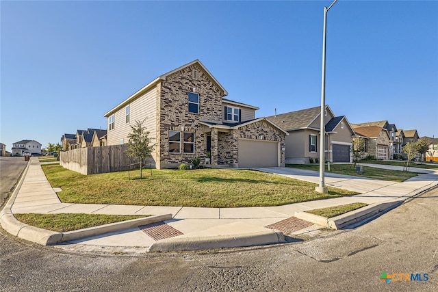 view of front of property featuring a garage and a front yard