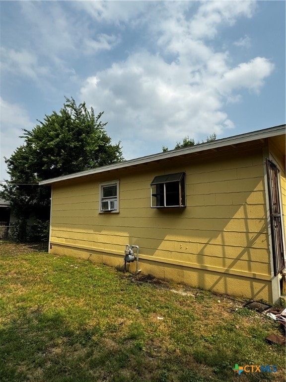 view of side of property with a yard